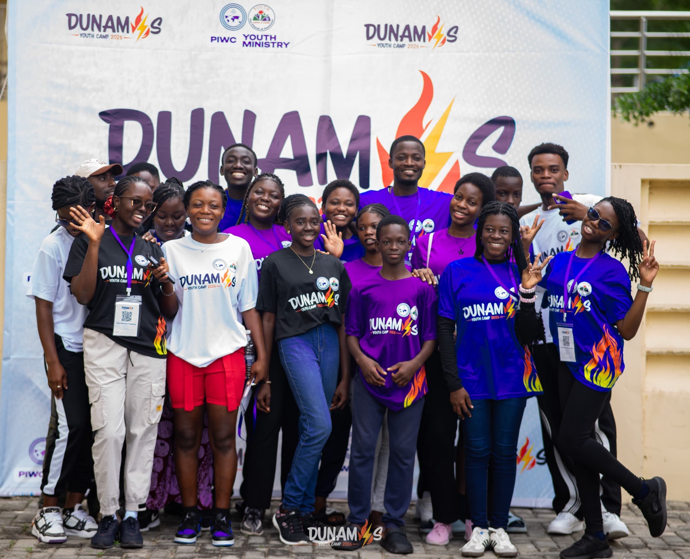 Campers gathered in front of the Dunamis backdrop at camp