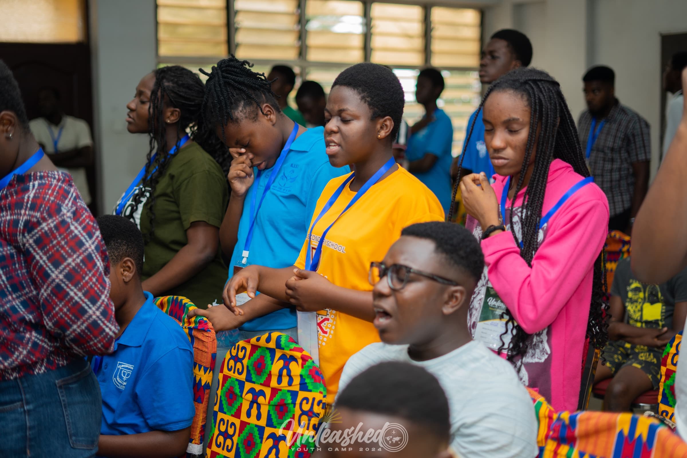 Youth gathered in worship at camp